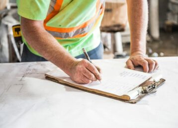 Construction worker writing plans